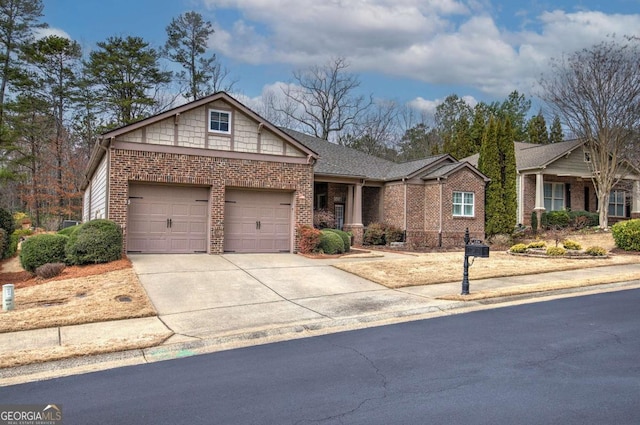 single story home with a garage, concrete driveway, and brick siding