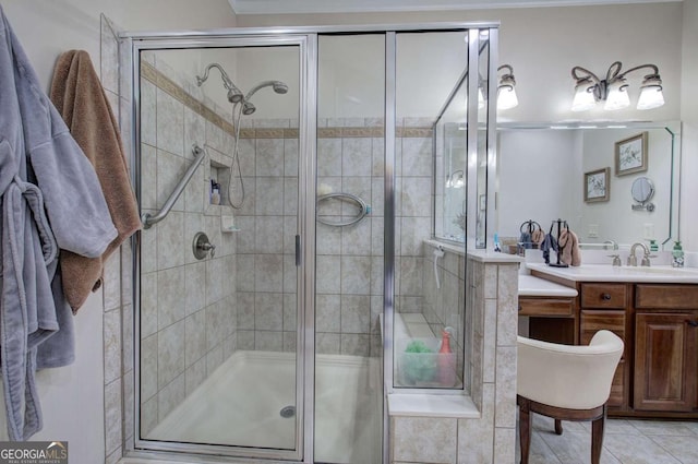 full bathroom featuring a stall shower, tile patterned flooring, and vanity