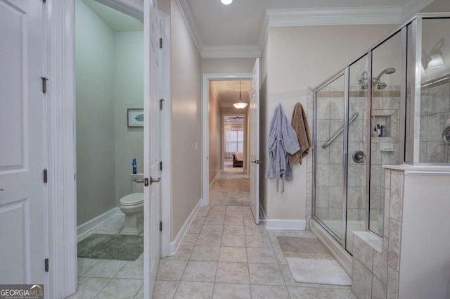 full bathroom with ornamental molding, baseboards, a shower stall, and toilet