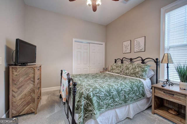 carpeted bedroom featuring a closet, visible vents, ceiling fan, and baseboards