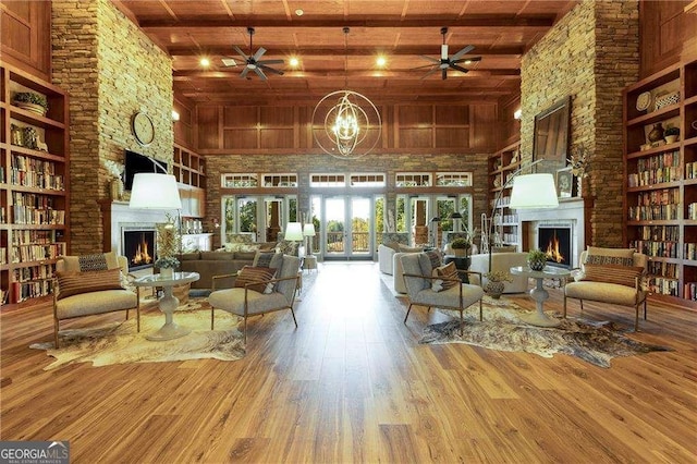 interior space with wooden ceiling, a fireplace, wood finished floors, and beam ceiling