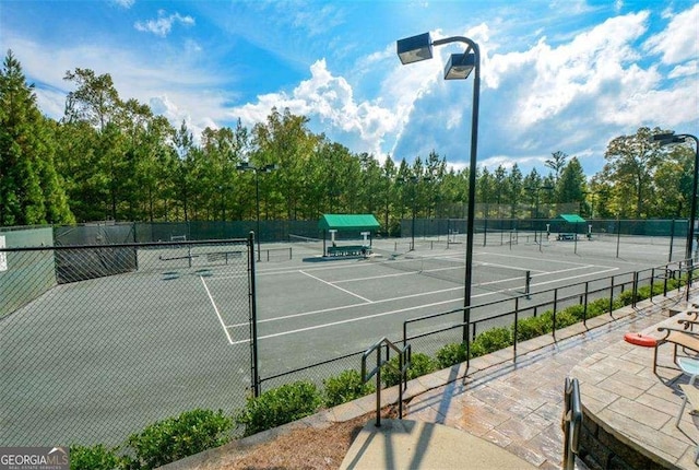 view of tennis court with fence