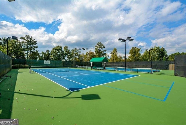 view of sport court featuring fence