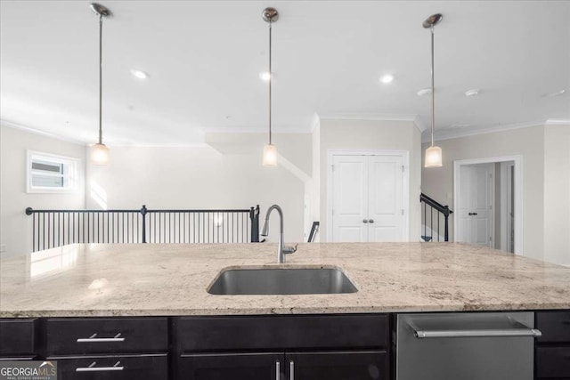 kitchen with decorative light fixtures, a sink, light stone countertops, dark cabinets, and dishwasher