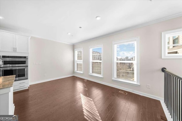 interior space featuring plenty of natural light, baseboards, and stainless steel double oven