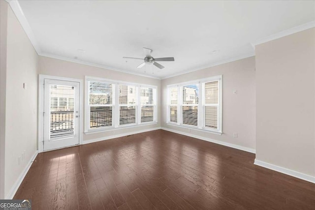 interior space featuring baseboards, ornamental molding, ceiling fan, and wood finished floors