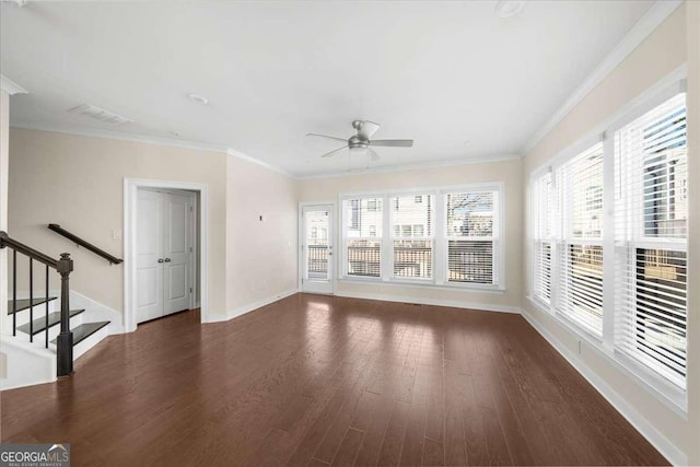 interior space with dark wood-style floors, crown molding, visible vents, baseboards, and stairs