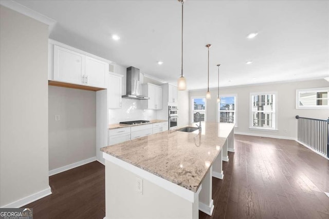 kitchen with wall chimney exhaust hood, dark wood finished floors, gas stovetop, and white cabinetry