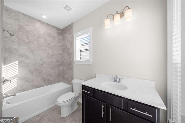 bathroom featuring visible vents, vanity, toilet, and tub / shower combination