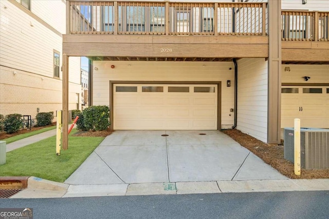 garage featuring cooling unit and concrete driveway