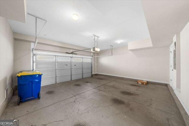 garage with baseboards and a garage door opener