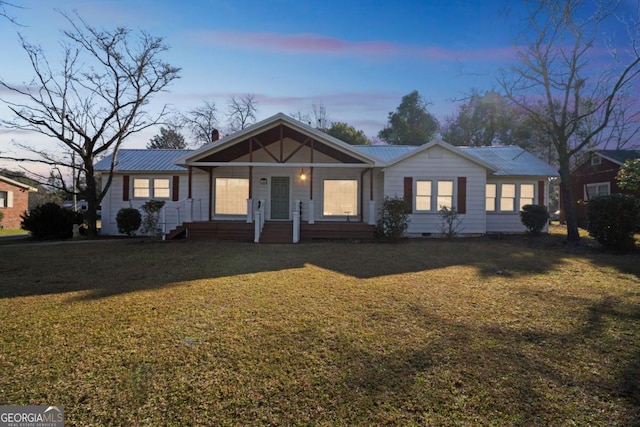 single story home with covered porch, metal roof, crawl space, and a front yard