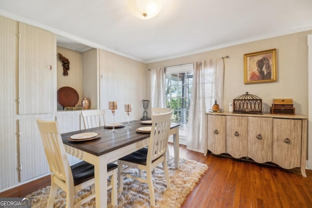 dining room with ornamental molding and dark wood-type flooring