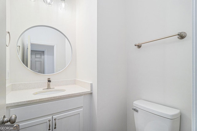 bathroom featuring toilet and vanity