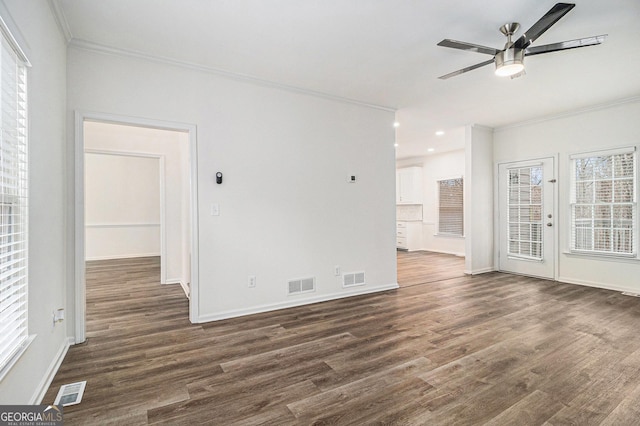 1320 Kay Ter SE, Conyers, GA 30013 - unfurnished living room with a ceiling fan, dark wood-style flooring, ornamental molding, and visible vents