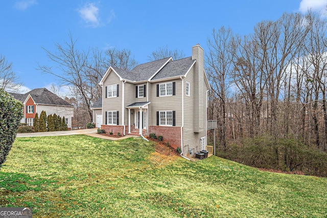 1320 Kay Ter SE, Conyers, GA 30013 - traditional home featuring a chimney, brick siding, a front lawn, and concrete driveway