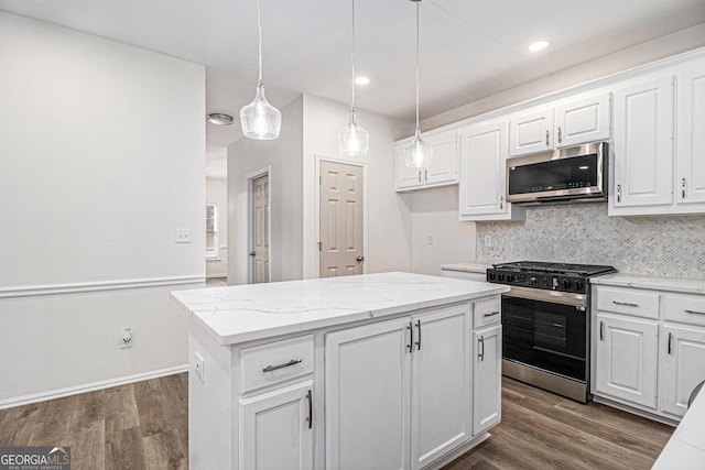 kitchen with stainless steel appliances, dark wood-type flooring, backsplash, and white cabinetry