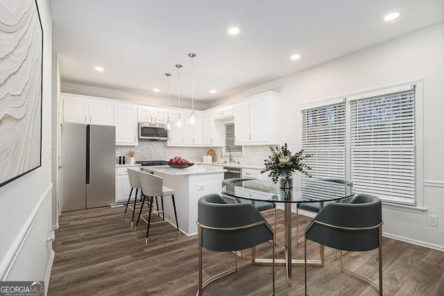 1320 Kay Ter SE, Conyers, GA 30013 - kitchen featuring white cabinetry, appliances with stainless steel finishes, a center island, and dark wood-style floors