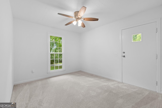 empty room with ceiling fan, carpet floors, and baseboards