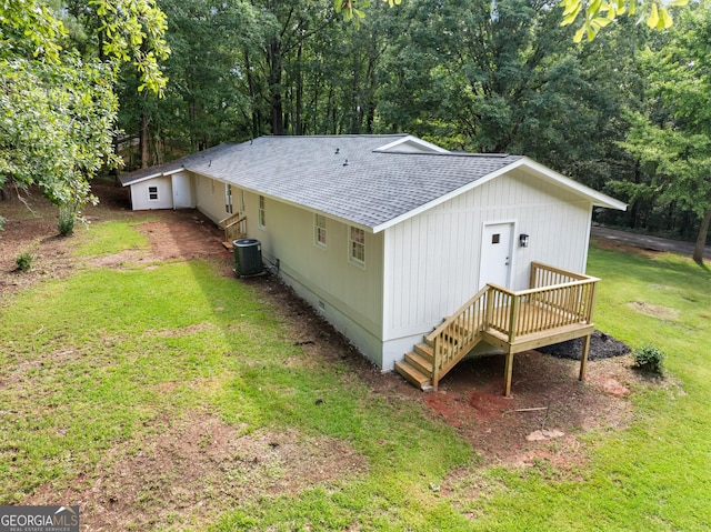 exterior space featuring crawl space, a shingled roof, a lawn, and central air condition unit