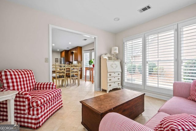 living room with recessed lighting, visible vents, and light tile patterned floors