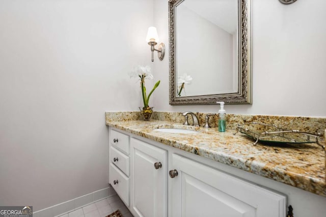 bathroom featuring tile patterned flooring, vanity, and baseboards