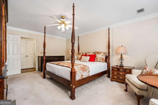 bedroom featuring carpet floors, a ceiling fan, visible vents, and crown molding