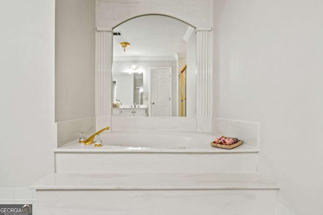 bathroom featuring a garden tub and crown molding