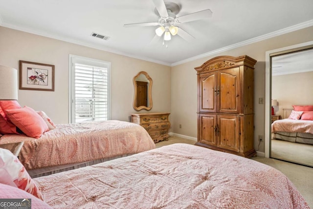 carpeted bedroom with baseboards, ceiling fan, visible vents, and crown molding