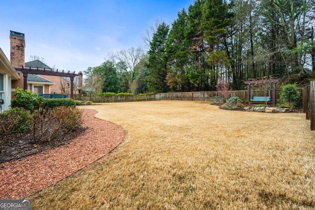 view of yard with a fenced backyard and a pergola