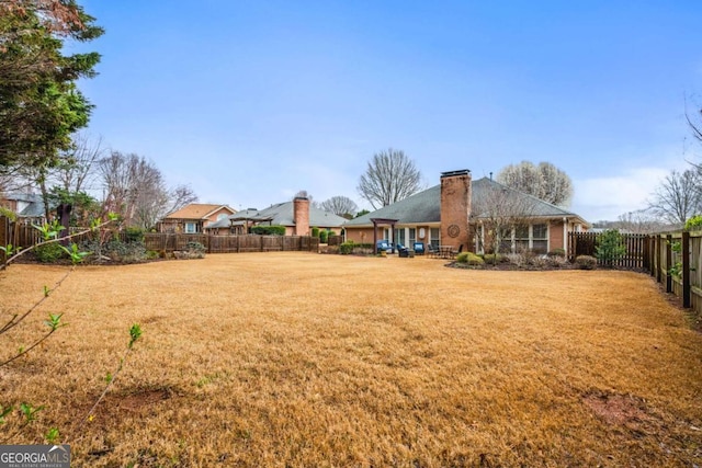 view of yard with a fenced backyard