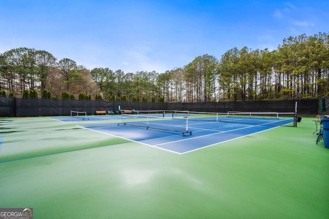 view of sport court with fence