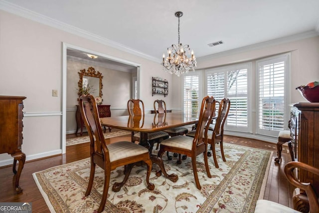 dining area with ornamental molding, visible vents, baseboards, and wood finished floors