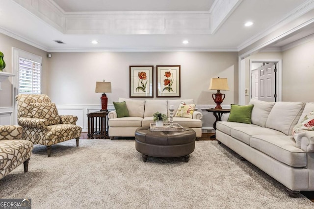 living area featuring a decorative wall, wainscoting, recessed lighting, and crown molding