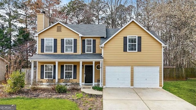 traditional home with driveway, a garage, a chimney, covered porch, and fence