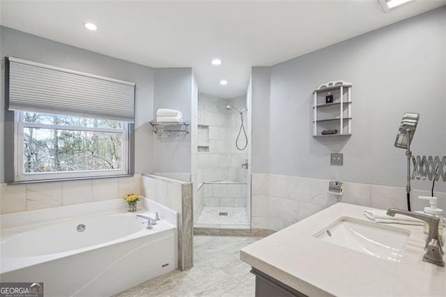 full bathroom featuring a bath, recessed lighting, tiled shower, and vanity