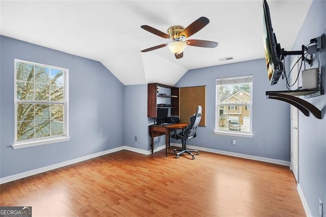 office with wood finished floors, a ceiling fan, visible vents, vaulted ceiling, and baseboards