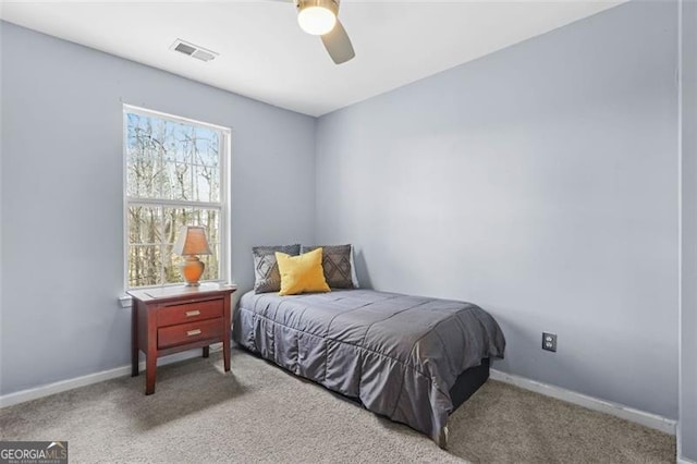 bedroom featuring a ceiling fan, carpet, visible vents, and baseboards