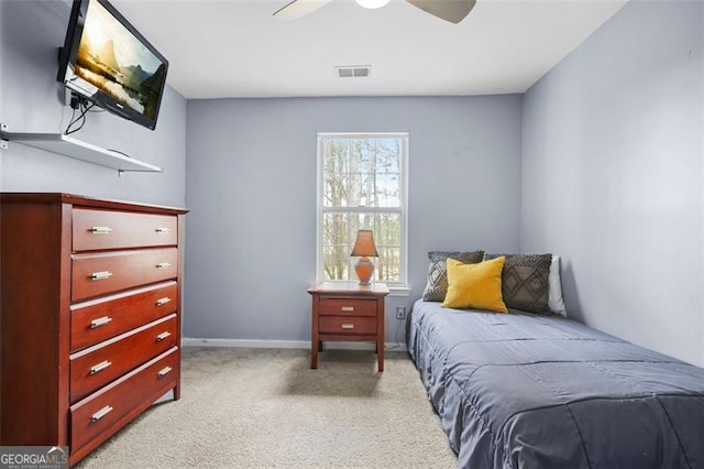 bedroom with light carpet, a ceiling fan, visible vents, and baseboards