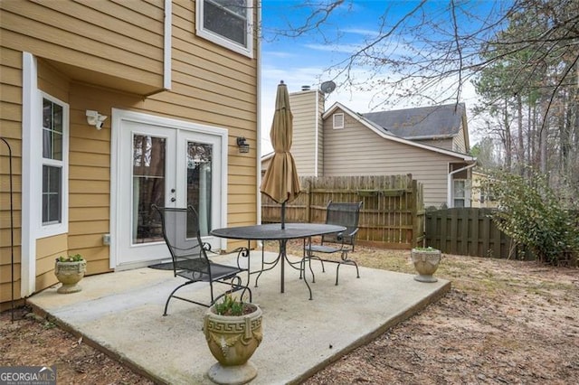 view of patio / terrace featuring fence and french doors