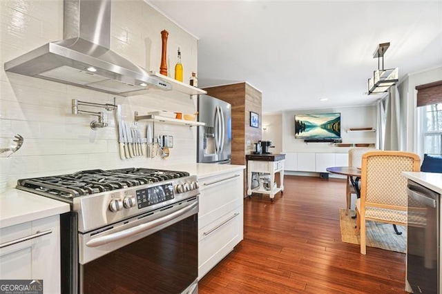 kitchen with light countertops, appliances with stainless steel finishes, dark wood-type flooring, wall chimney range hood, and beverage cooler