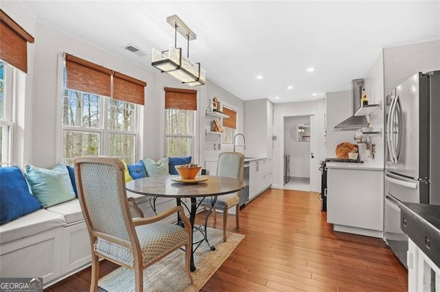 dining room with recessed lighting, visible vents, and wood finished floors