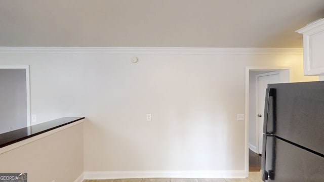 interior space featuring baseboards and ornamental molding