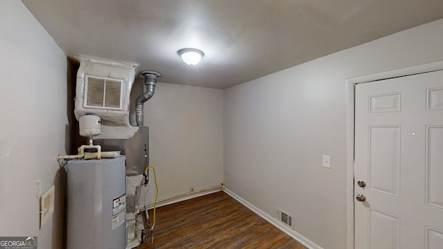 utility room featuring visible vents and water heater
