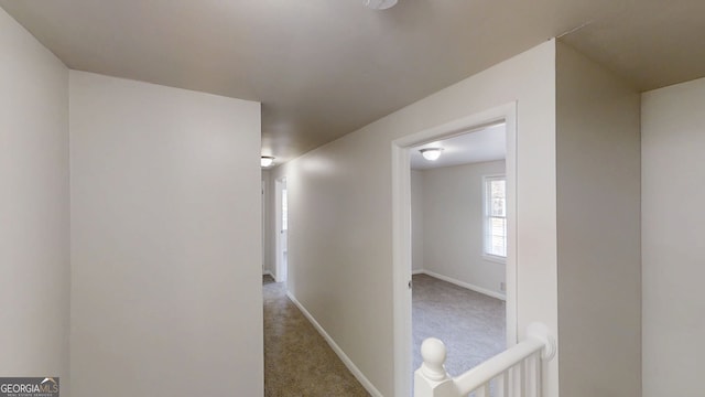 hallway with carpet and baseboards