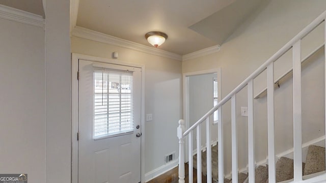 entrance foyer featuring ornamental molding, stairway, visible vents, and baseboards