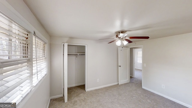 unfurnished bedroom featuring carpet floors, a closet, a ceiling fan, and baseboards