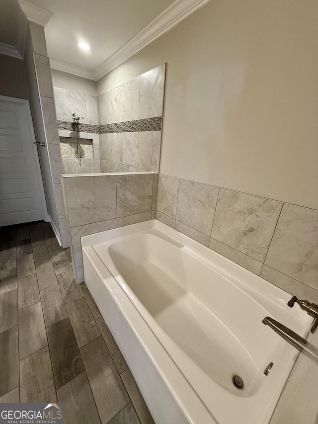 bathroom with ornamental molding, wood tiled floor, a tub to relax in, and walk in shower