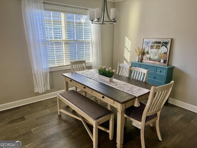 dining area featuring baseboards, a chandelier, and dark wood finished floors