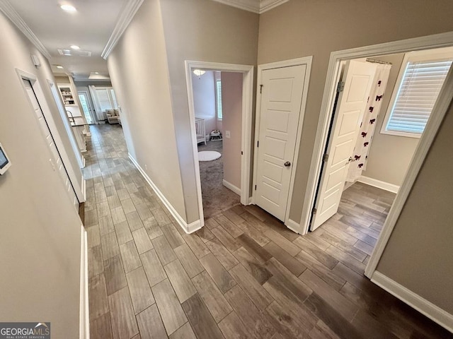 hallway with crown molding, recessed lighting, baseboards, and wood tiled floor